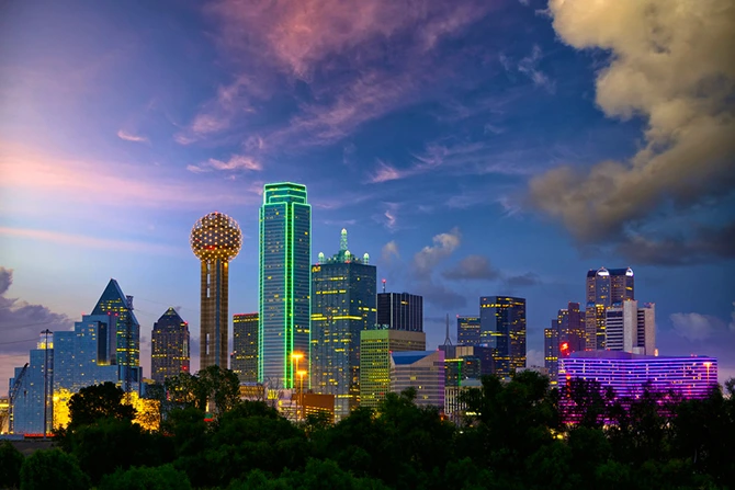 Dallas skyline at dusk, featuring illuminated skyscrapers and the iconic Reunion Tower, representing the vibrant business landscape for FileMaker Pro development services.