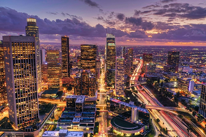 Los Angeles skyline at sunset, showcasing vibrant city lights and bustling traffic, representing the dynamic business environment for FileMaker Pro development solutions.