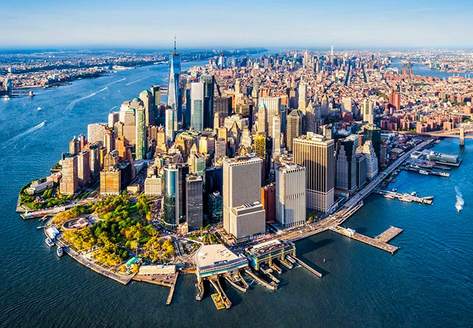 Aerial view of New York City skyline featuring modern skyscrapers, waterfront, and bustling urban landscape, representing a hub for FileMaker Pro development solutions.